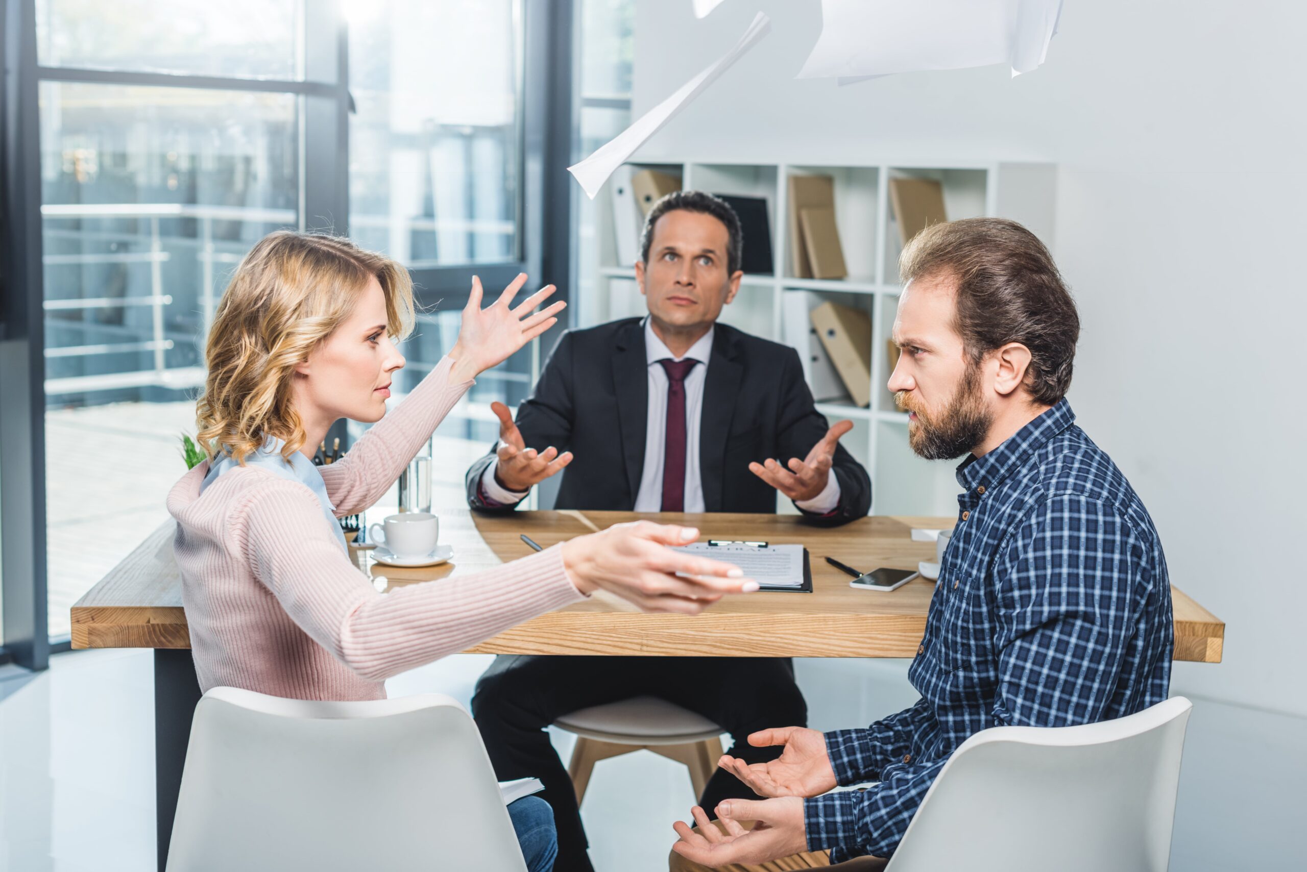 Couple arguing with a lawyer about property division in Texas divorce.
